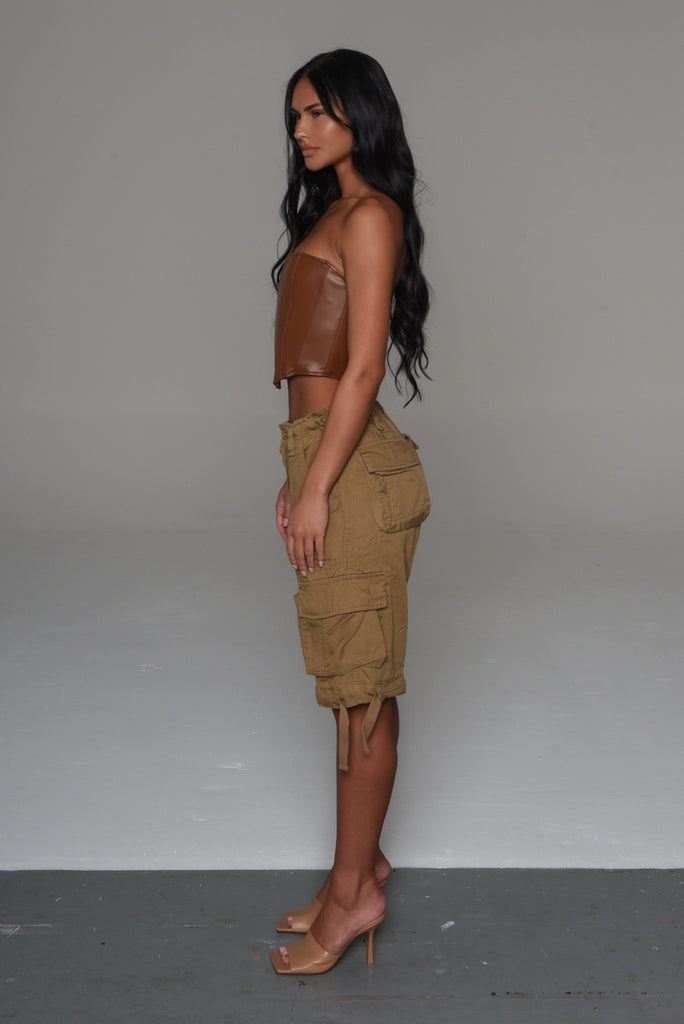 female in brown leather corset and oversized beige nude brown vintage short cargo pants shorts
